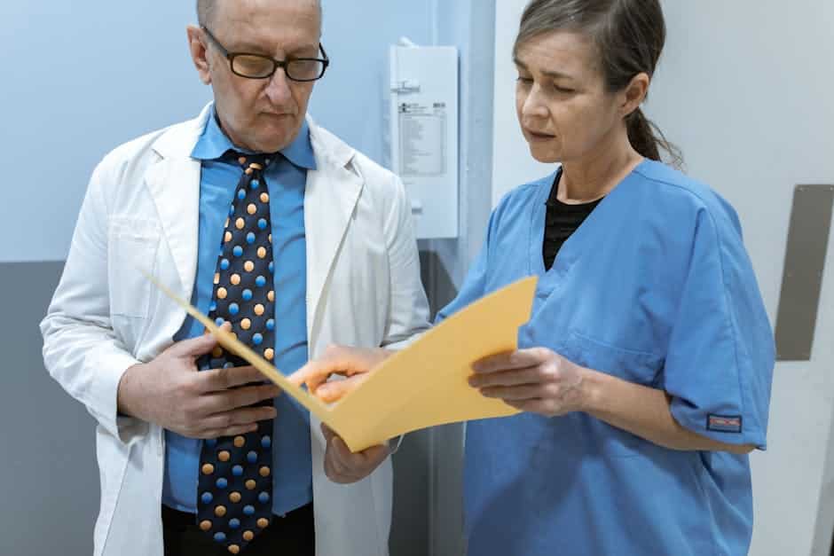 oral surgeon reviewing medical records and a dental procedure cross-reference for medical cross coding for oral surgery procedures